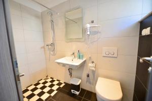 a bathroom with a sink and a toilet at Apartments Petarcica Beach in Zavala +55 photos