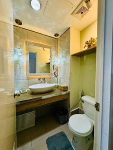 a bathroom with a sink and a toilet at Aesthetic Functional Minimalist Space Sunvida Tower SV1716 in Cebu City