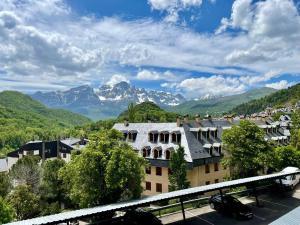 a view of a building with mountains in the background at Mirador de Telera - Precioso apartamento en el pueblo con espectaculares vistas in Panticosa