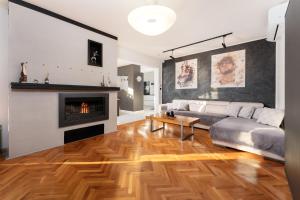 a living room with a couch and a fireplace at Apartment Stella in Rabac