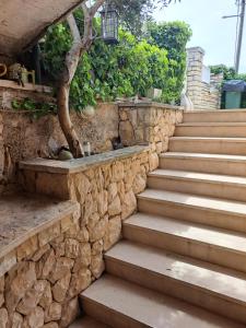 a set of stairs with a stone wall at Apartment Summer in Šibenik