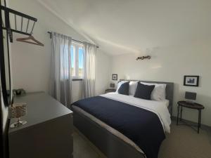 a bedroom with a large bed and a window at Apartmani Gemma in Premantura