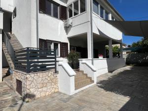 a building with a staircase in front of it at Apartmani Gemma in Premantura +21 photos