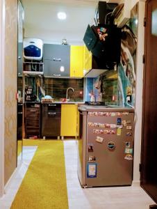 a kitchen with a refrigerator with magnets on it at apartament eforie nord in Eforie Nord