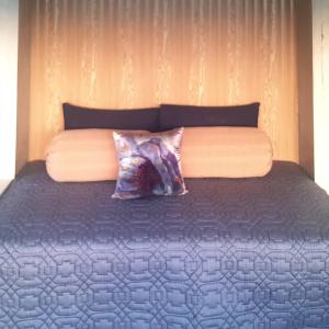 a bed with two pillows on top of it at Bhurban Valley Cottages 3 in Bhurban +22 photos
