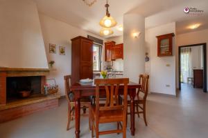 a kitchen and dining room with a wooden table and chairs at Casa Letizia - Welchome in Rocca San Giovanni