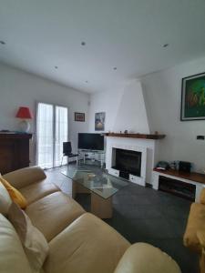 a living room with a couch and a fireplace at Il Giardino di Piero - LT-0029 in Salto