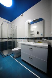 a bathroom with a sink and a shower and a toilet at Mount Villa Kvariati in Kvariati