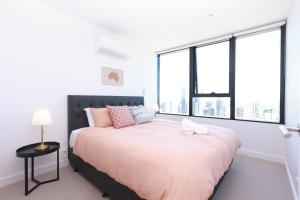 una camera da letto con un letto grande e grandi finestre di 09D 2Bedroom Abnb-Style Ocean view Apt with Free parking a Melbourne