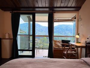 a bedroom with a door open to a balcony at 泰森會館 in Lugu Lake