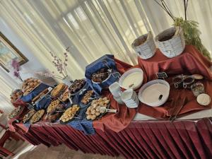 a table topped with plates and bowls of food at Hotel Villa Rosa in Misano Adriatico +35 photos