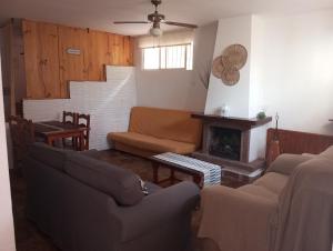 a living room with a couch and a fireplace at Apartamento con acceso directo a la playa in Rincón de la Victoria +11 photos