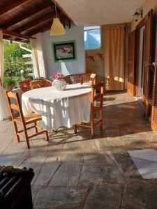 a dining table and chairs on a patio at Elani house in Elani