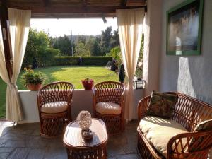 a patio with chairs and a couch and a table at Elani house in Elani