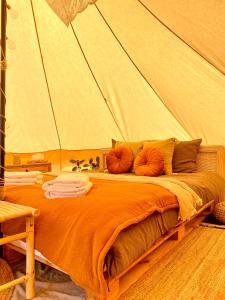 ein Schlafzimmer mit einem Bett in einem Zelt in der Unterkunft BohoFyn in Nyborg