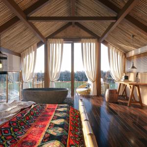 a large room with a tub and a large window at Villa 109 Thang Mây in Hanoi