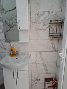 a bathroom with a sink and a marble wall at Tinina Basta in Sutomore +70 photos