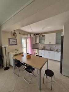 a kitchen with a table and chairs in a room at RAJ Beach Front Apartment in Agia Triada