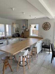a kitchen with a large wooden table and chairs at Maison à louer au pays basque in Anglet