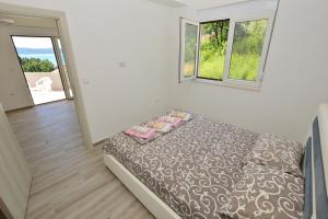 Postel nebo postele na pokoji v ubytování Apartmani Tomic Igalo