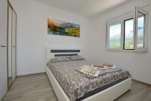 Postel nebo postele na pokoji v ubytování Apartmani Tomic Igalo