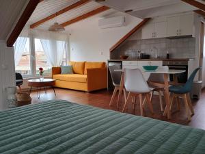 a living room and kitchen with a couch and a table at Perispit in Lefkada