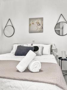 um quarto branco com uma cama branca e um espelho em MATEOS APARTMENT WINDMILLS TOWN em Míconos