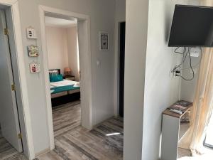 a room with a television and a bedroom with a bed at Villa Sea House in Byala