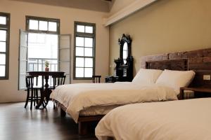 Postel nebo postele na pokoji v ubytování 莊同益民宿 Zhuang Tongyi Homestay