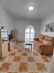 a living room with a couch and a table at Apartamento Playa Tanguillos del Mar in Cádiz +39 photos