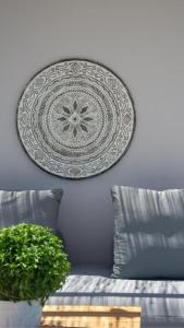 a plate hanging on a wall next to a couch at Cavalier Suites Nikiana Lefkada AV Properties in Nikiana +20 photos