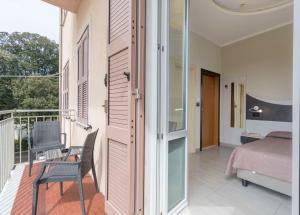 a room with a balcony with a bed and a window at Hotel Roma in Marina di Massa