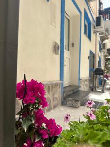 a bunch of pink flowers in front of a building at Itaca 3 in Lipari