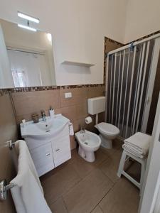 a bathroom with a sink and a toilet and a mirror at B&B Fior di Mare in Porto Cesareo +27 photos