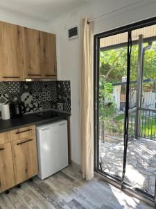 a kitchen with a sliding glass door to a patio at Villa Sea House 3 in Byala
