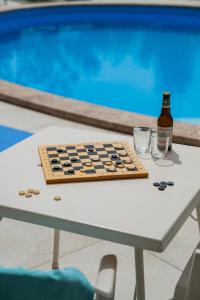 a bottle of beer sitting on a table next to a chessboard at Casa Pertosa in Taormina