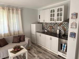 a living room with a couch and a kitchen at Villa Sea House in Byala