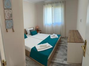 a bedroom with two beds with towels on them at Villa Sea House in Byala