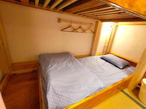 大阪市にあるHostel Caranashiの小さなベッド1台が備わる小さな客室です。