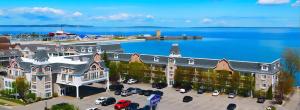an aerial view of a large building with a parking lot at Hamilton Inn Select Beachfront in Mackinaw City