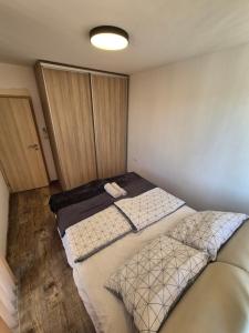 A bed or beds in a room at Apartmán TTT
