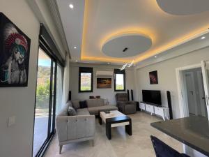 a living room with a couch and a table at Villalakehouse in Dalaman