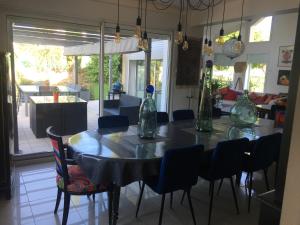 ein Esszimmer mit einem Tisch und Stühlen mit Vasen darauf in der Unterkunft Mille et Une Bulles 51 in Brugny-Vaudancourt