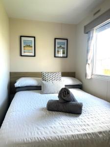 a bedroom with two beds with towels on them at Berwick Holiday Park Haven in Berwick-Upon-Tweed