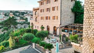 an apartment building with a patio and a garden at Hotel Pirate Old Town in Ulcinj