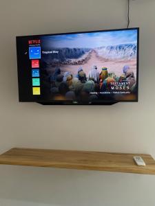 a flat screen tv sitting on top of a shelf at Tropical Stay Accommodations Dao in Tagbilaran City