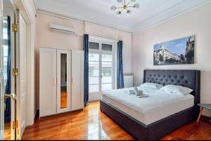 a bedroom with a large bed and a window at Elegant apartment in Syntagma square in Athens