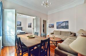 a living room with a table and a couch at Elegant apartment in Syntagma square in Athens