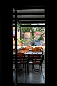a patio with a table and chairs on a balcony at StarHostel in Kutaisi