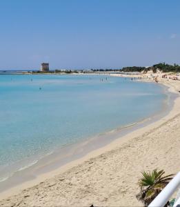 a view of a beach with people in the water at B&B Fior di Mare in Porto Cesareo